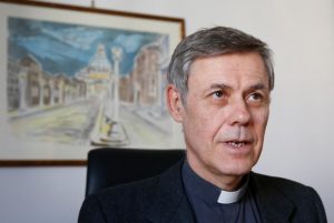 Jesuit Father Carlo Casalone, a member and consultant at the Pontifical Academy for Life, is pictured in his office at the Vatican Dec. 5. The Pontifical Academy for Life has added robotics to its list of specialized areas of study. (CNS photo/Paul Haring) See VATICAN-LETTER-ROBOTS-LIFE Jan. 3, 2018.