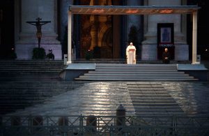 Pope Francis gives his extraordinary blessing "urbi et orbi" (to the city and the world) in an empty St. Peter's Square at the Vatican March 27, 2020. The blessing was livestreamed because of the coronavirus pandemic. (CNS photo/Guglielmo Mangiapane, pool via Reuters) See POPE-BLESSING-COVID-19 March 27, 2020.